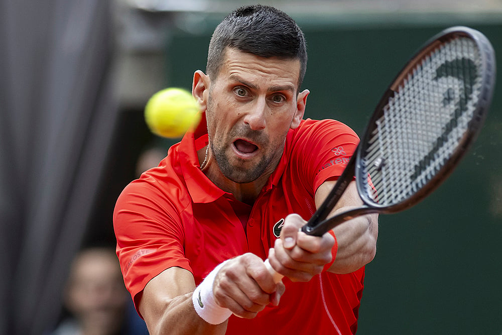 | Photo: Martial Trezzini/Keystone via AP : Novak Djokovic returns a ball to Tallon Griekspoor